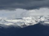 Clouds over Snow Covered Mountains