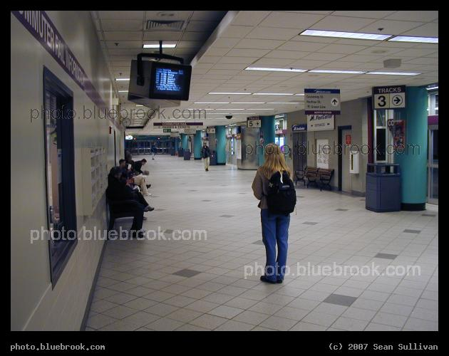 Waiting Area - Passenger watching a train announcement screen at North Station, Boston MA