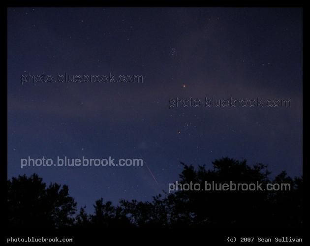 Perseids 2007 - A Perseid meteor in morning twilight from Wompatuck State Park, Hingham MA.  The Pleiades, Mars and the Hyadies shine above the meteor.