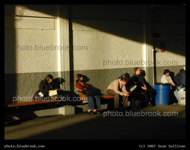 Lechmere Busway - The afternoon sun illuminates passengers waiting for a bus at the MBTA Lechmere train station, Cambridge MA