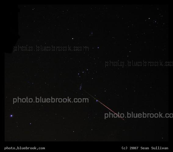 Leonid in Orion - A Leonid meteor crossing the constellation Orion, with the bright star Sirius in the lower left, and the Hyades star cluster in the upper right.