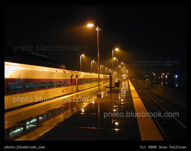 Train in the Rain - A commuter rail train at the Newburyport MBTA train station, reflected in the wet platform, Newburyport MA