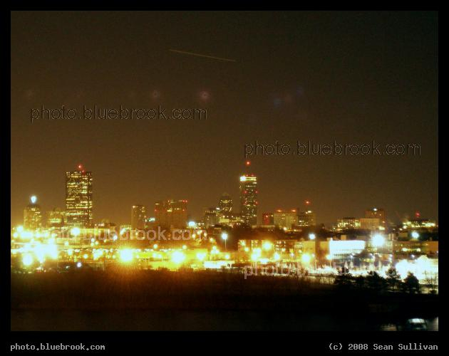 Launch over Boston - Above the Boston skyline, highlighted by the Hancock and Prudential skyscrapers, the space shuttle Endeavour launches into space on mission STS-123.  The shuttle