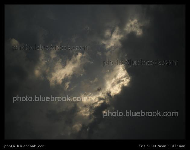 Light and Clouds - A shaft of late afternoon sunlight shining through storm clouds before a downpour, Somerville MA