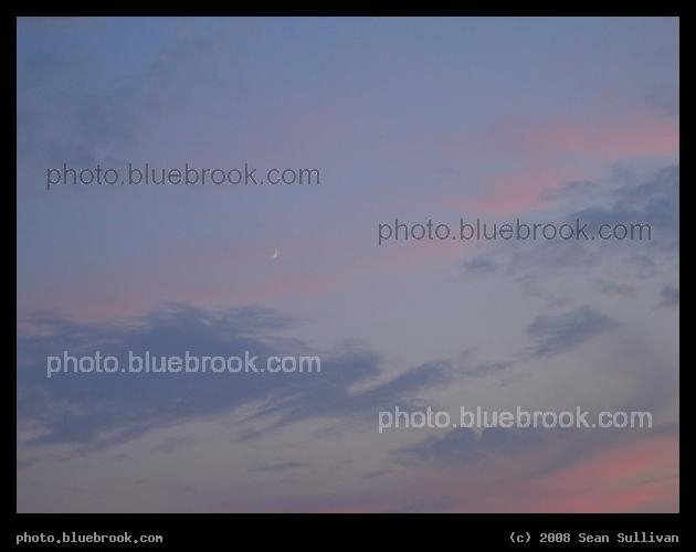 Pastel Sky - High clouds are illuminated in pink by the setting sun, while lower clouds are blue, and the crescent moon stands above all.  Somerville MA