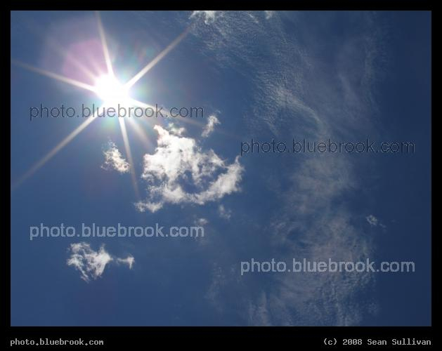 Noon - The brilliant summer sun, and ripples of thin clouds, in the midday sky.  Plymouth MA