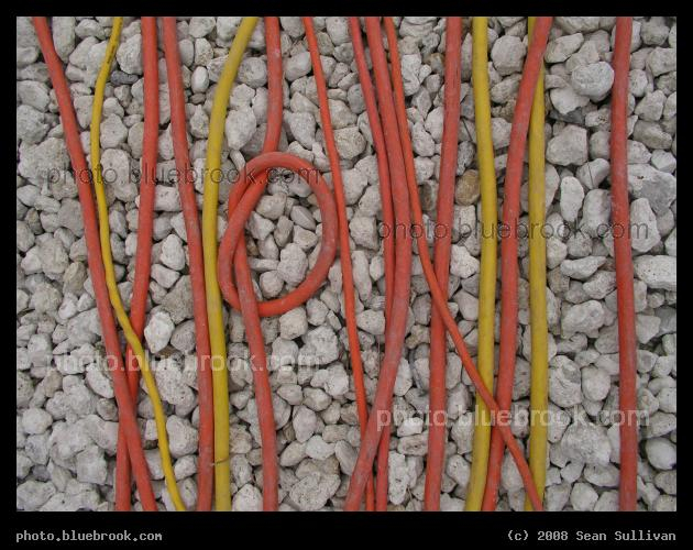 Electrical Cables - A group of electrical cables crossing a gravel strip at the Kennedy Space Center press site, Cape Canaveral FL