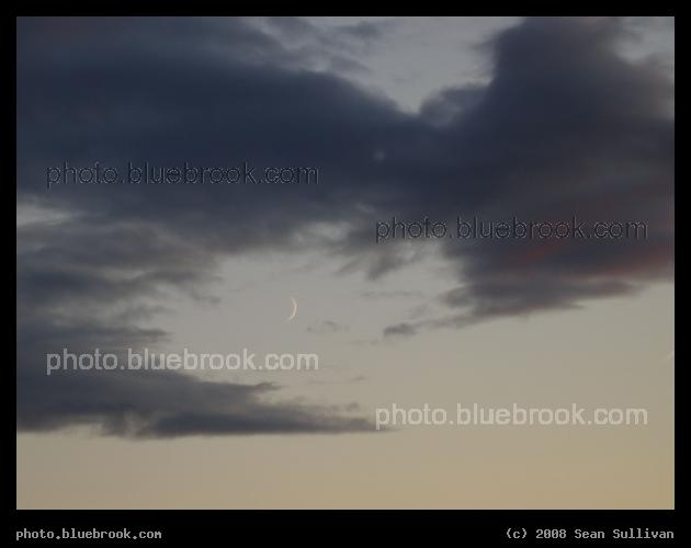 Thin Crescent - A waxing crescent moon peeks through a gap in the clouds, Medford MA