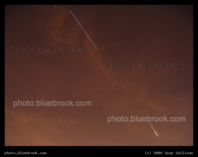 Co-Orbital - The International Space Station (above, trailing) and the Space Shuttle Discovery (below, leading) move along the same orbital trajectory, but separated by about 250 miles, a day after the shuttle departed the station during flight STS-128.  During this 15-second exposure from Charlestown MA, the two spacecraft were setting in the northeastern sky.