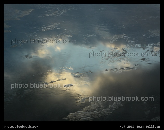 Sky in the Ice - Reflection of sky and clouds in the partially frozen Charles River, Boston MA