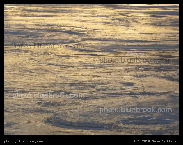 Lilac and Gold Swirls - An oblique view of the frozen surface of the Charles River, Boston MA