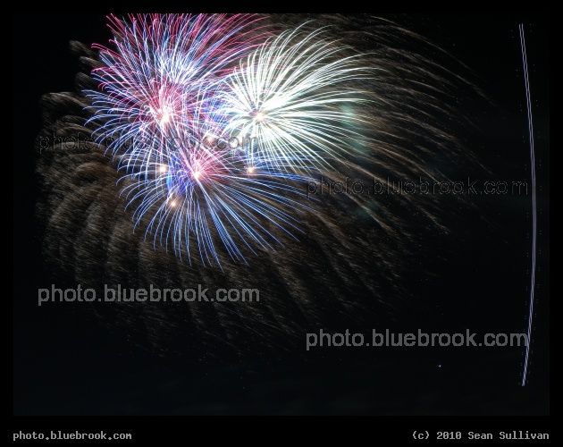 Fireworks and Airplane - In this 20-second exposure, an airplane departing Boston