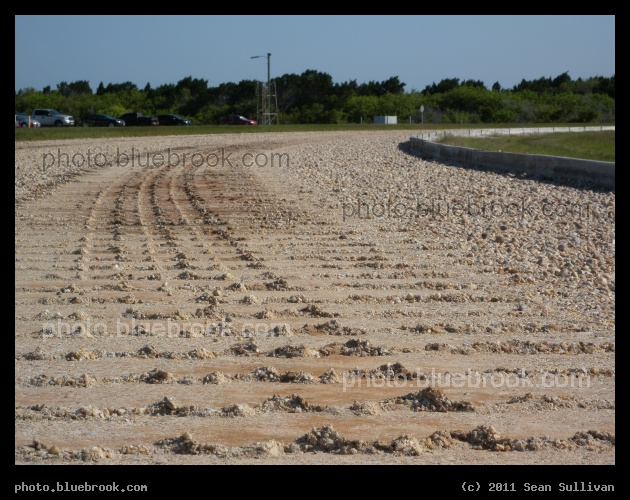 Crawlerway Tracks - Treadmarks of the NASA Crawler on the Kennedy Space Center crawlerway, a rock highway used for transporting the space shuttle, near the approach to launch pad 39-A