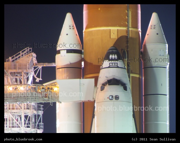Orbiter Access Arm - Space Shuttle Endeavour on launch pad 39-A, at the first RSS rollback for flight STS-134, Kennedy Space Center FL. Access to the crew cabin is through the White Room and Orbiter Access Arm on the left side.