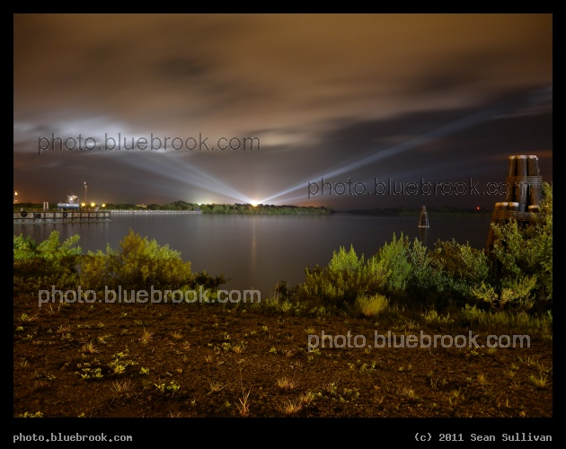 Floodlights on Atlantis - On the night before the final space shuttle launch, xenon floodlights at the Kennedy Space Center illuminate shuttle Atlantis and the clouds