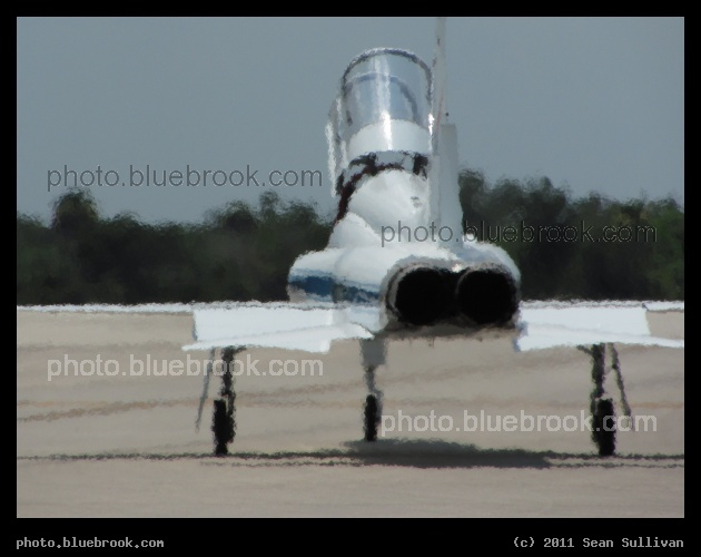 Shimmering Heat - A NASA T-38 aircraft piloted by astronaut Jim Dutton preparing for departure from the Shuttle Landing Facility, Kennedy Space Center FL. The heat from the exhaust creates a shimmering effect on the scene.
