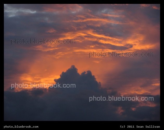 Dawn Light - A sunbeam peaking out from behind clouds at sunrise, Kennedy Space Center FL