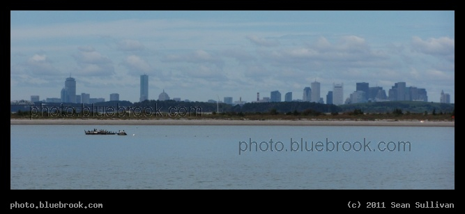 Boston Skyline Panorama - A view of Boston (Back Bay district on left, Financial District on right) across Boston Harbor and Peddocks Island (foreground), from a ferry offshore Hull MA