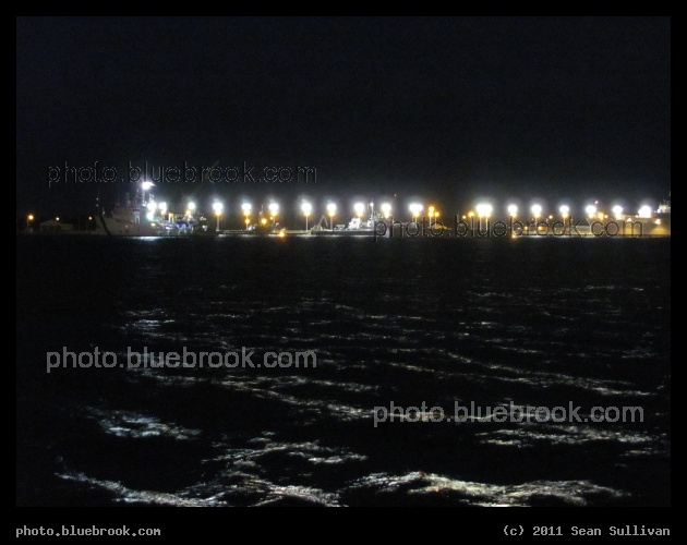 Port Canaveral Lights - A space shuttle solid rocket booster, retrieved after flight, floating on the water at Port Canaveral FL