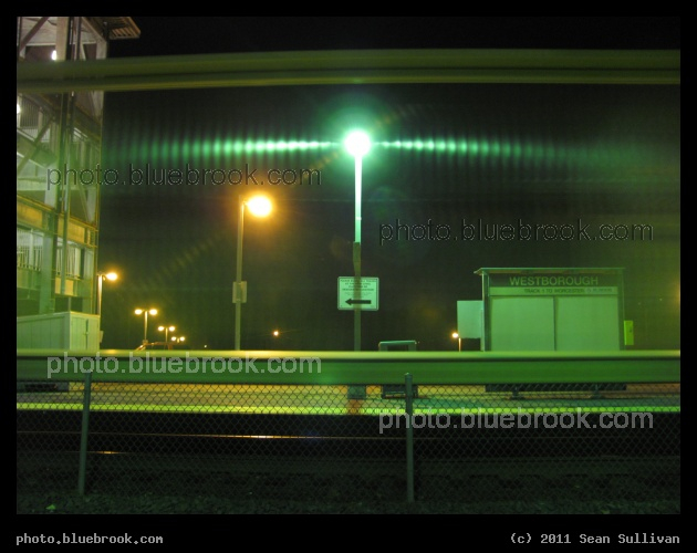Westborough Freight - A 1-second time exposure captured an illumination effect while a freight train passed through MBTA Westborough station, as the AC lighting produced a strobe effect capturing the passage of an empty centerbeam freight car