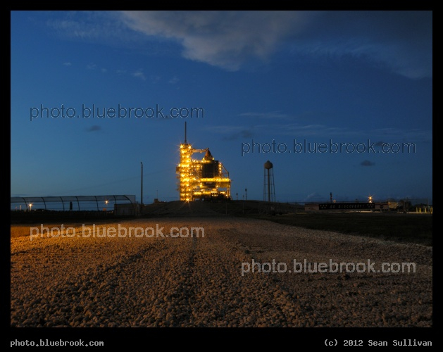 Spaceport at Dusk - Kennedy Space Center launch pad 39-A in evening twilight, as seen from the crawlerway south of the launch pad.  Prior to the first launch attempt for space shuttle Discovery on mission STS-133.