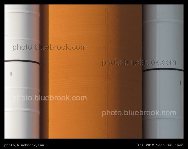 Boosters and External Tank - A close-up view of the space shuttle stack (external tank flanked by solid rocket boosters) for STS-135, the final space shuttle mission, from the north side of launch pad 39-A (the side of the tanks opposite the space shuttle)
