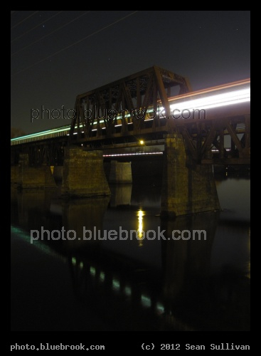 Haverhill Bridge - An outbound MBTA commuter rail train crossing a bridge over the Merrimack River between Bradford and Haverhill stations, Haverhill MA