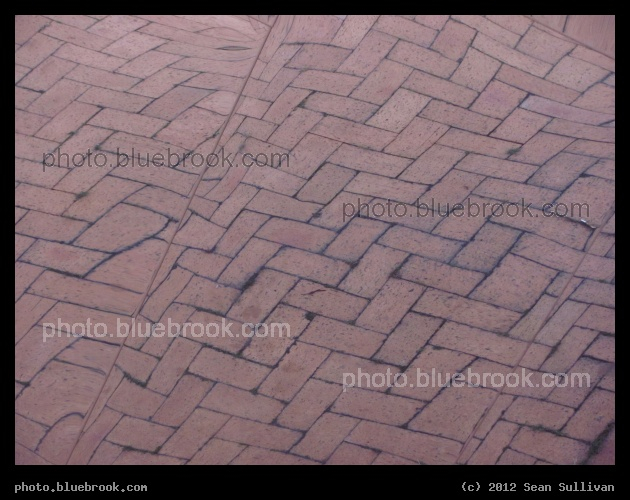 Brick - A reflection of a brick walkway, in the side of a metallic building.  Massachusetts Institute of Technology, Cambridge MA