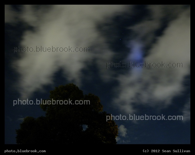 Eagle in the Clouds - The bright star Altair, and the three central stars of the constellation Aquila (the Eagle), through clouds.  Somerville, MA