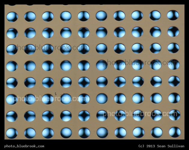 Phase and Distance - A view of holes in the near and far sides of a freight rail car, Dallas TX